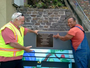 SF DPW colleagues positioning plaque for installation